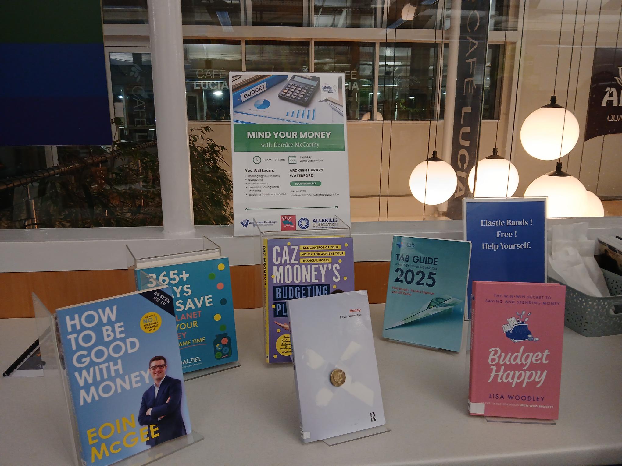 Poster for FLIT Workshop surrounded by notable books on personal finance